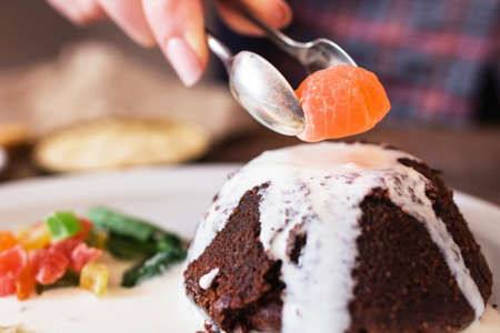 Decorating cake with marmalade closeup. Confectioner finishing his sweet cake with final ingredient, free space. Confectionery, sugar, dessert cooking conceptの写真素材