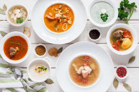 Assortment of hot soups flat lay. Top view on restaurant table with variety of warm fasting dishes on it. Buffet, menu, lunchtime, healthy food conceptの写真素材