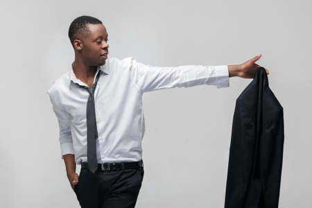 Businessman leaving office job. Going to the new level, next stage. African american guy on grey background.の写真素材