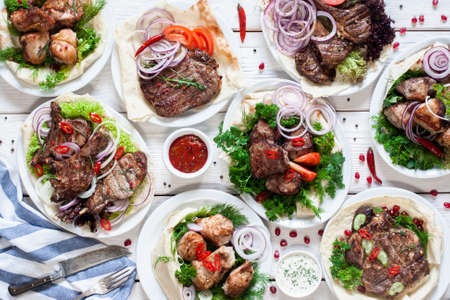 Assortment of grilled meat meals flat lay. Top view on restaurant table with variety of barbecue snacks. Restaurant menu, delicious food, dieting, gourmet conceptの写真素材
