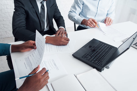 Board of directors meeting. Business owner, top-manager and managing director working with documents...
