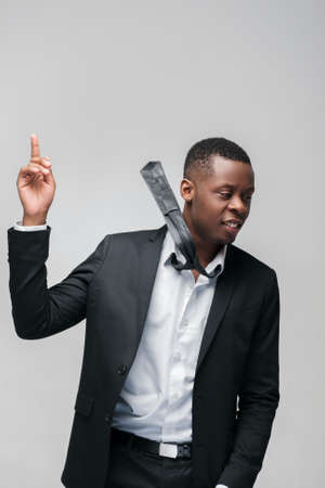 African american guy solved problem. Getting new idea, great decision, finding right way. Grey background with free space.の写真素材