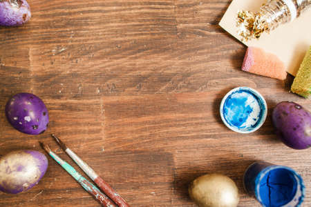 Preparations for easter celebration. Painting eggs on rustic wooden table with copy space.の写真素材