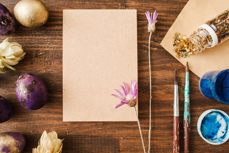 Masterclass of painting easter eggs. Colorful eggs on rustic wooden table with copy space for text.の写真素材