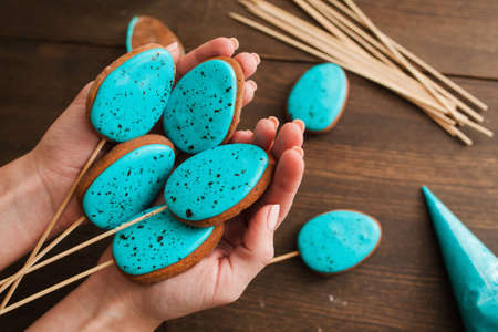 Homemade easter cake pops with blue icing on rustic wooden table top viewの写真素材