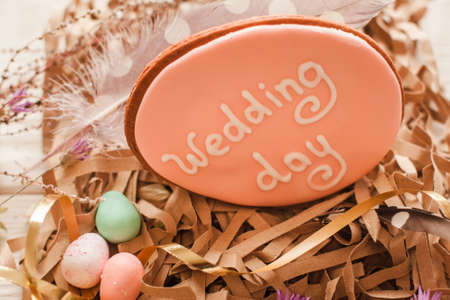 Handmade wedding cookie decorated with lettering closeup. Preparing for celebration. Culinary art, woman craftsmanship, good wife conceptの写真素材