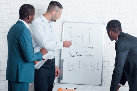 Business analytic making graph report of company work. Analyzing financial figures denoting the...