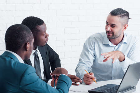 New employees studying. Great chance for foreign workers. Interracial cooperation about training specialists.の写真素材