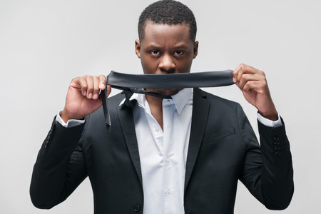 Muteness african american man. Indifference, rejection, reluctance to talk, non-acceptance. Portrait on grey background.の写真素材