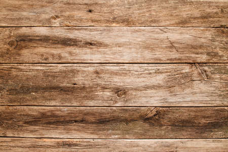 Empty grungy wooden table flat lay. Rustic used shabby table texture, free space for text or advertisementの写真素材
