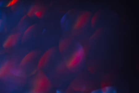 Abstract blurred glittering shine, blue and red. Blur light bokeh, night background. Christmas wallpaper decorations concept. New year holiday festive backdrop. Sparkle circle celebrations display.の写真素材