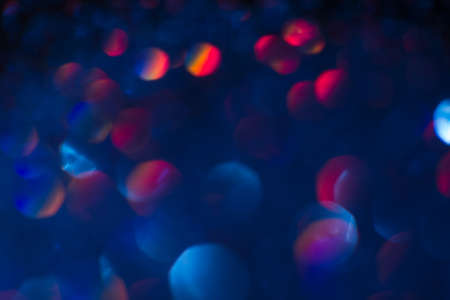 Abstract blur light bokeh, blue and red. Blurred glittering shine , night background. Christmas wallpaper decorations concept. New year holiday festive backdrop. Sparkle circle celebrations display.の写真素材
