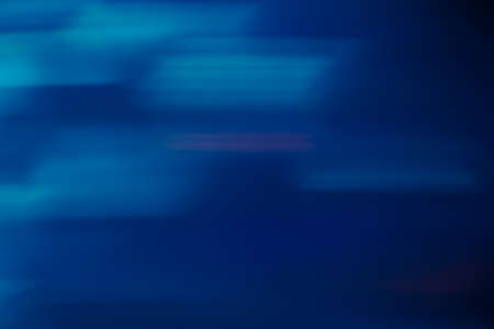 Blue blurred motion abstract background. Defocused shiny lights backdrop. Christmas wallpaper decorations conceptの写真素材