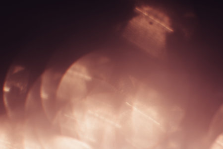 Abstract blurred glittering shine background, pink sepia. Blur light bokeh. Christmas wallpaper...