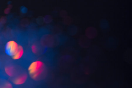 Abstract blurred glittering shine background, blue and red. Blur light bokeh. Christmas wallpaper decorations concept. New year holiday festive backdrop. Sparkle circle celebrations display.の写真素材