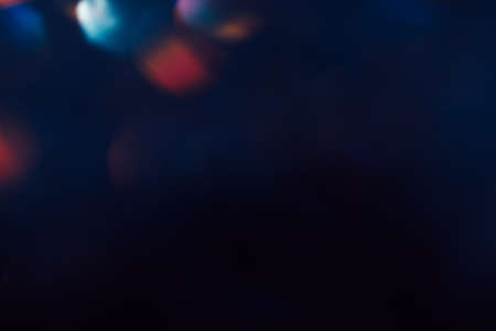 Abstract blurred glittering shine, teal and red. Blur light bokeh, night background. Christmas wallpaper decorations concept. New year holiday festive backdrop. Sparkle circle celebrations display.の写真素材