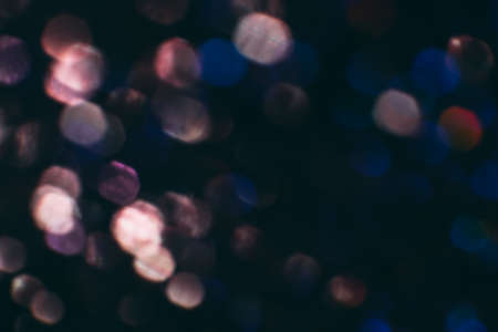 Abstract blurred glittering shine, blue and pink. Blur light bokeh, night background. Christmas wallpaper decorations concept. New year holiday festive backdrop. Sparkle circle celebrations display.の写真素材