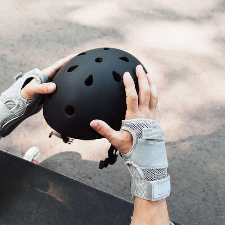 Skateboard halmet and gloves acessrise. Head and hands care protection from injoury. Extreme sport headwear stuff for skaterの写真素材