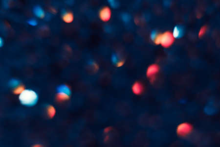 Abstract blurred glittering shine, teal and red. Blur light bokeh, night background. Christmas wallpaper decorations concept. New year holiday festive backdrop. Sparkle circle celebrations display.の写真素材