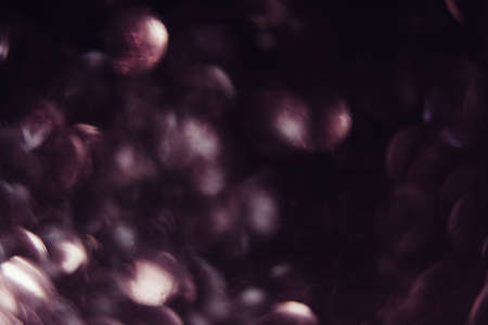 Abstract blurred glittering shine background, violet color. Blur light bokeh. Christmas wallpaper decorations concept. New year holiday festive backdrop. Sparkle circle celebrations display.の写真素材