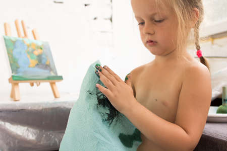 Early childhood education. Creative little girl. Small art painter in working process, interesting hobby for children, artistic backgroundの写真素材