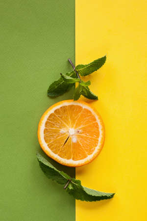 Citrus slice and mint on colorful background with free space. Summer, freshness and ingredients for cold drink, top view imageの写真素材