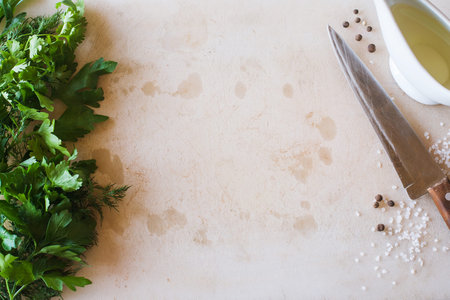 Cutting wooden desk with parsley and knife. Cooking process, herbs and healthy organic food, top view pictureの写真素材