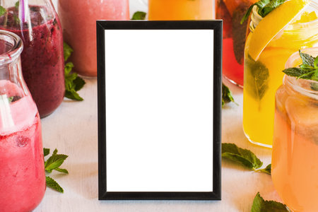 Blank picture frame with fresh fruit drinks around. Food blogs, menu and recipes for web sites of...