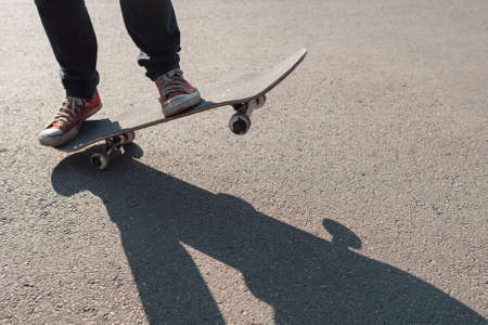Manual ride trick. Holding balance exercise. Freestyle practice of skateboardering on downtown.の写真素材