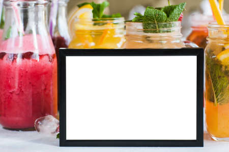 Picture frame with fresh fruit drinks behind. Food blogs, menu and recipes for web sites of cafe and restaurant, close up picture with copy spaceの写真素材