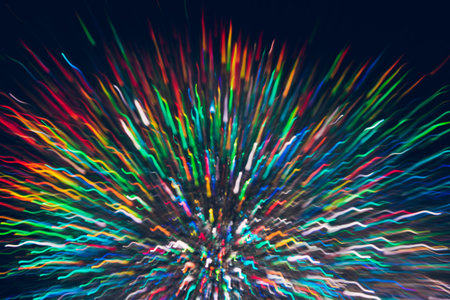 Abstract background of colorful lines in motion on black. Bokeh of defocused curves, blurred rainbow...