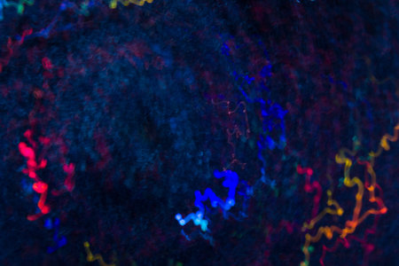 Abstract background of colorful waves in motion on black. Bokeh of defocused curves, blurred neon...
