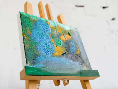 Colorful abstract painting in selective focus. Artistic picture on easel closeup, bright colors, art conceptの写真素材