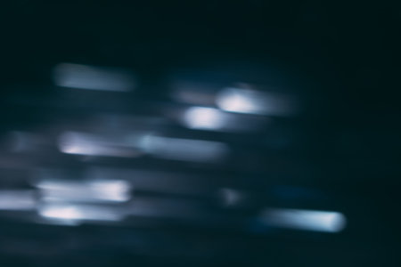 Abstract background of defocused white lights in motion. Glowing urban backdrop, heavy night illumination city glimmers, bokehの写真素材