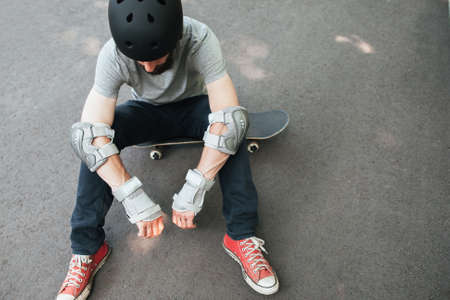 Professional skater has bad day in competition, crash and failure on training, exhaustion and refreshment conceptの写真素材