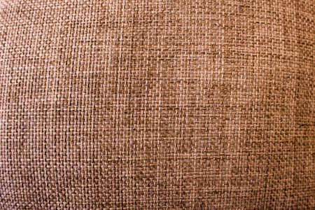 Rustic cloth texture. Abstract background top view. Brown fabric backdrop with free space, color textile material closeupの写真素材