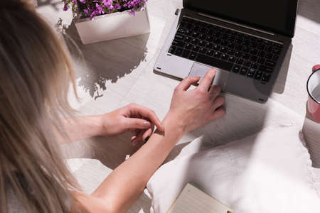 Modern blogger workplace. Lady typing on laptop. Remote job in creative place top view, unrecognizable female, social media communicationの写真素材
