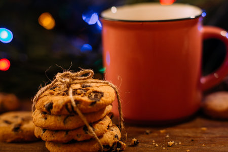 Delicious Christmas holiday with latte and cookies. Close up cup of warm drink and sweet scones on...
