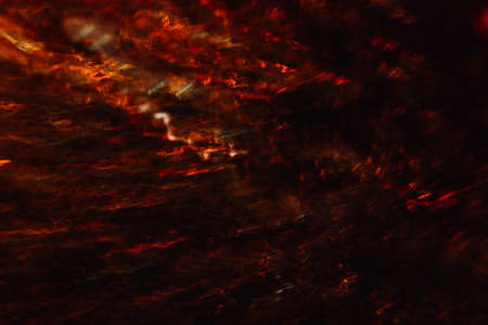 Abstract background of colorful crankles in motion on black. Bokeh of defocused curves, blurred neon yellow and red leds, hellfire and smoke, abyss and seven circles of hellの写真素材