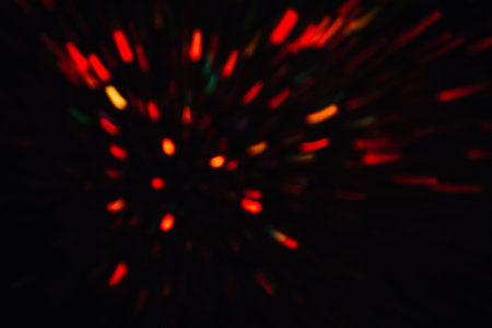 Abstract background of colorful lines in motion on black. Bokeh of defocused splashes, blurred...