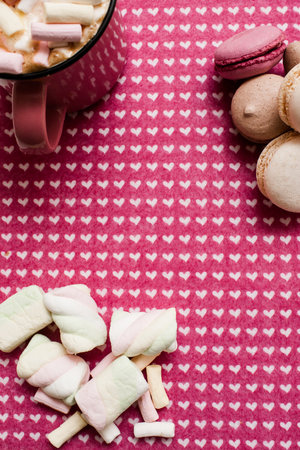 Composition from latte, macaroons and marshmallow. Sweet colorful cakes and hot drink with zephyrs...