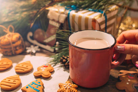 Christmas bakery with latte close up. Festive background of culinary art with homemade gingerbread cookies and warm drink. Family celebration, holiday decoration and New Year traditions conceptの写真素材