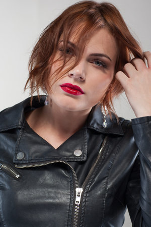 Modern stylish youth. Confident female. Fashion woman portrait closeup on grey background. Fashionable hair advertising, style conceptの写真素材