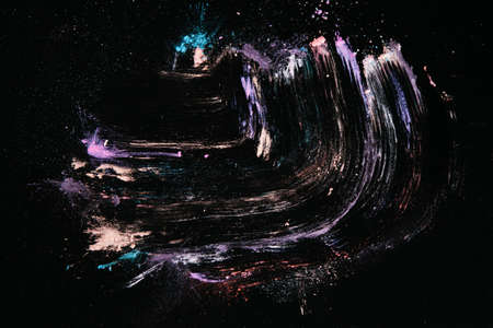 Creative abstract pigment cosmetic background, top view. Colorful powdery colourants similar to rainbow shapeの写真素材