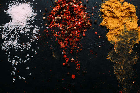 food spice salt mustard pepper tumeric dark background conceptの写真素材