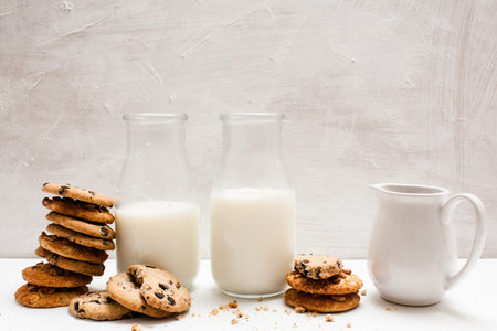 Wholegrain products eating with milk, close up. Chocolate scones in one line with bottles and...