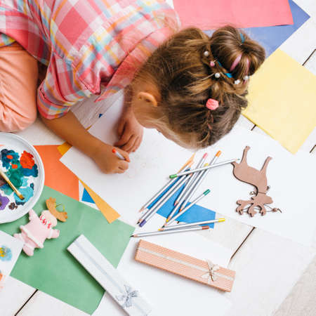 Handmade for kids. Greeting cards creation. Artistic child, early children education top view. Creative baby girl, creativity conceptの写真素材