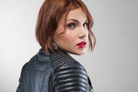 Seductive female look. Stylish life. Beautiful young woman portrait closeup. Grey background, fashion conceptの写真素材