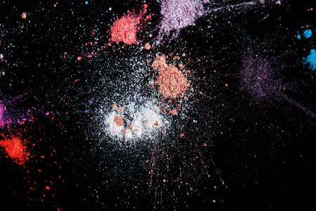 Professional abstract pigment cosmetics background, top view. Colorful powdery splashes and colourants for creative make upの写真素材