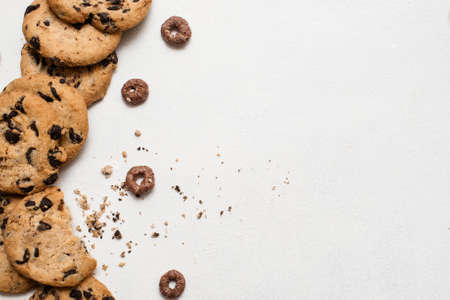 Wholegrain chocolate scone on white background, top view with free space on right. Delicious cookies, culinary art of homemade pastry, sweet bakery conceptの写真素材